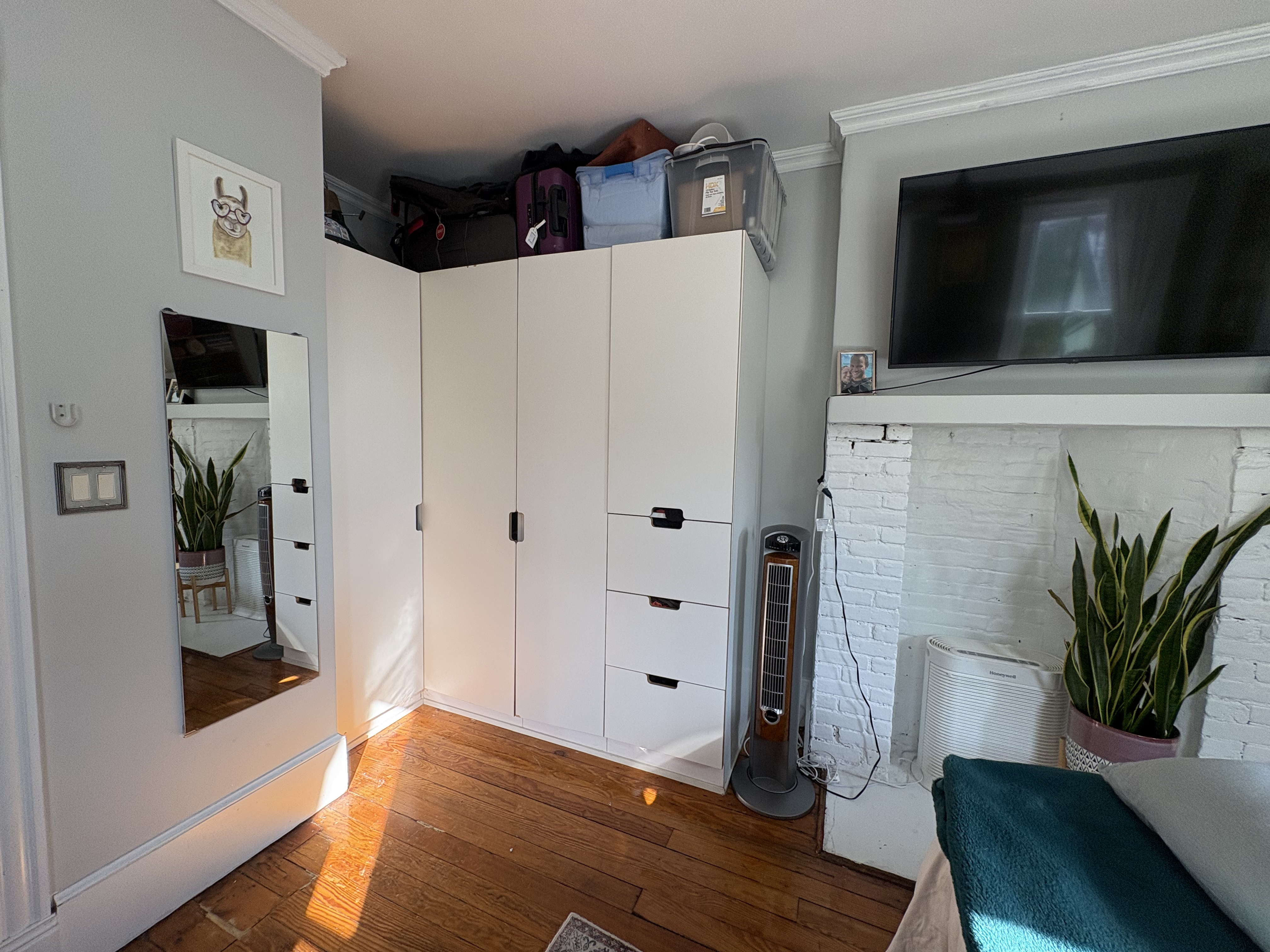 304 7th Avenue, Unit 3 Brooklyn, NY 11215 - Photo 7 of 15 a view of a livingroom with wooden floor and a flat screen tv