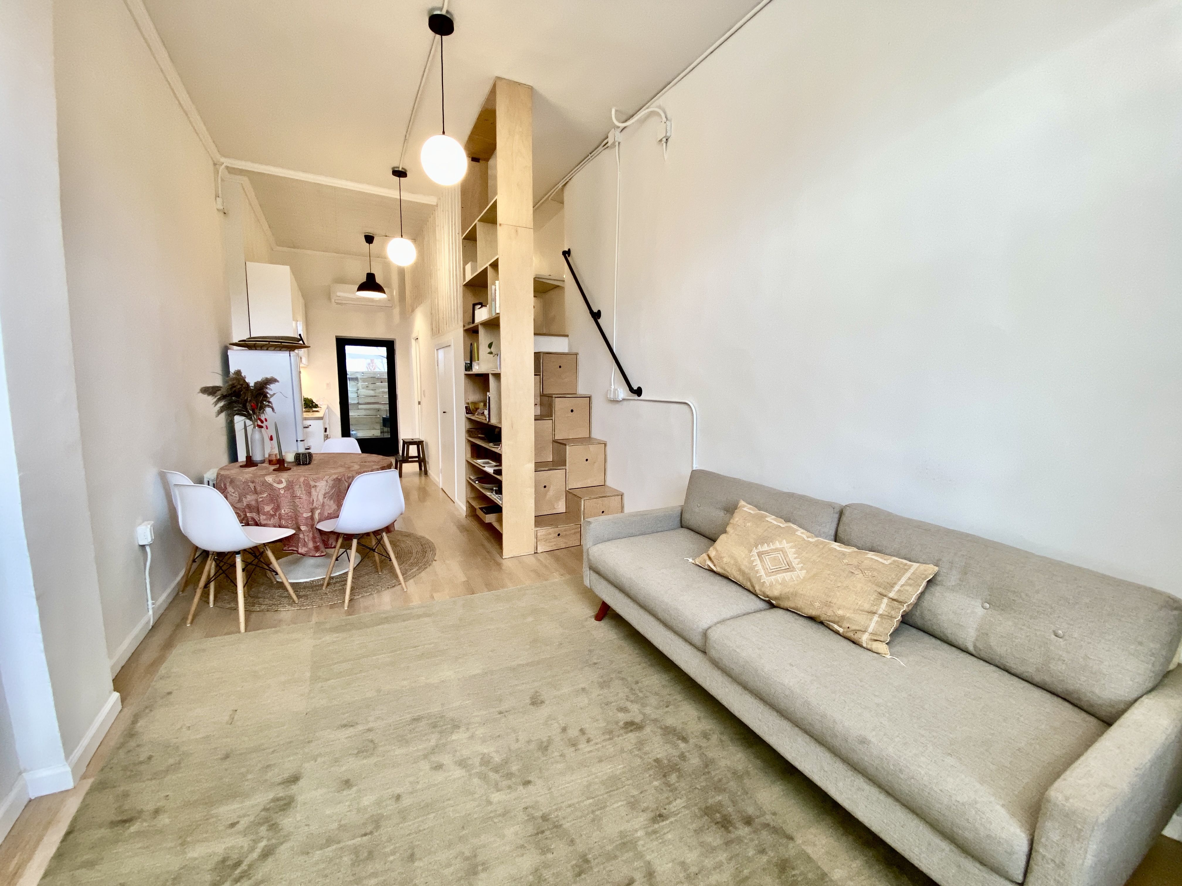 a living room with furniture and wooden floor