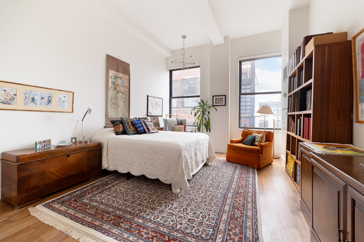 140 West 22nd Street, Unit PHC Manhattan, NY 10011 - Photo 10 of 15 a bed room with a bed and a couch