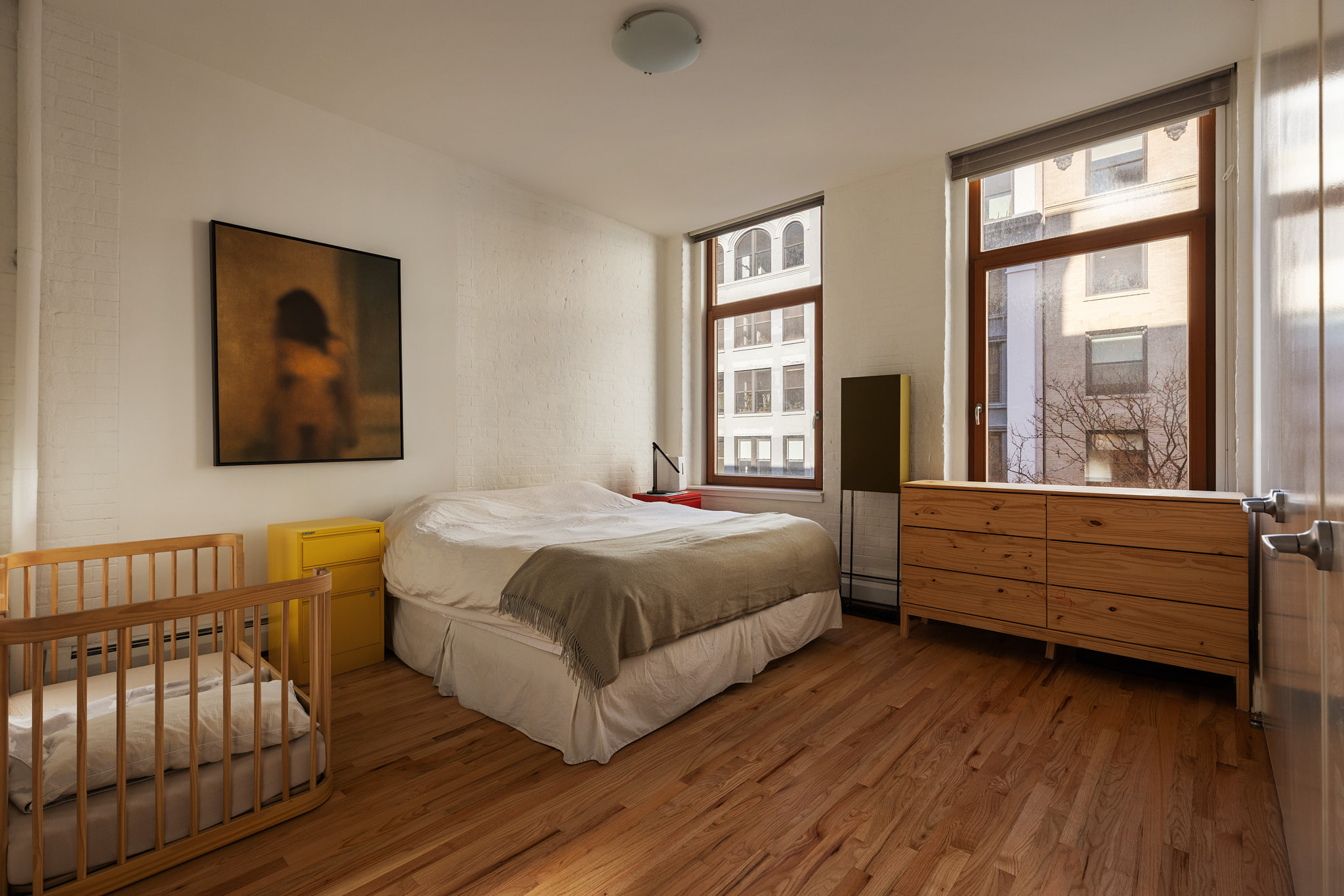 124 West 24th Street, Unit 4A Manhattan, NY 10011 - Photo 6 of 13 a bed room with a bed and a window
