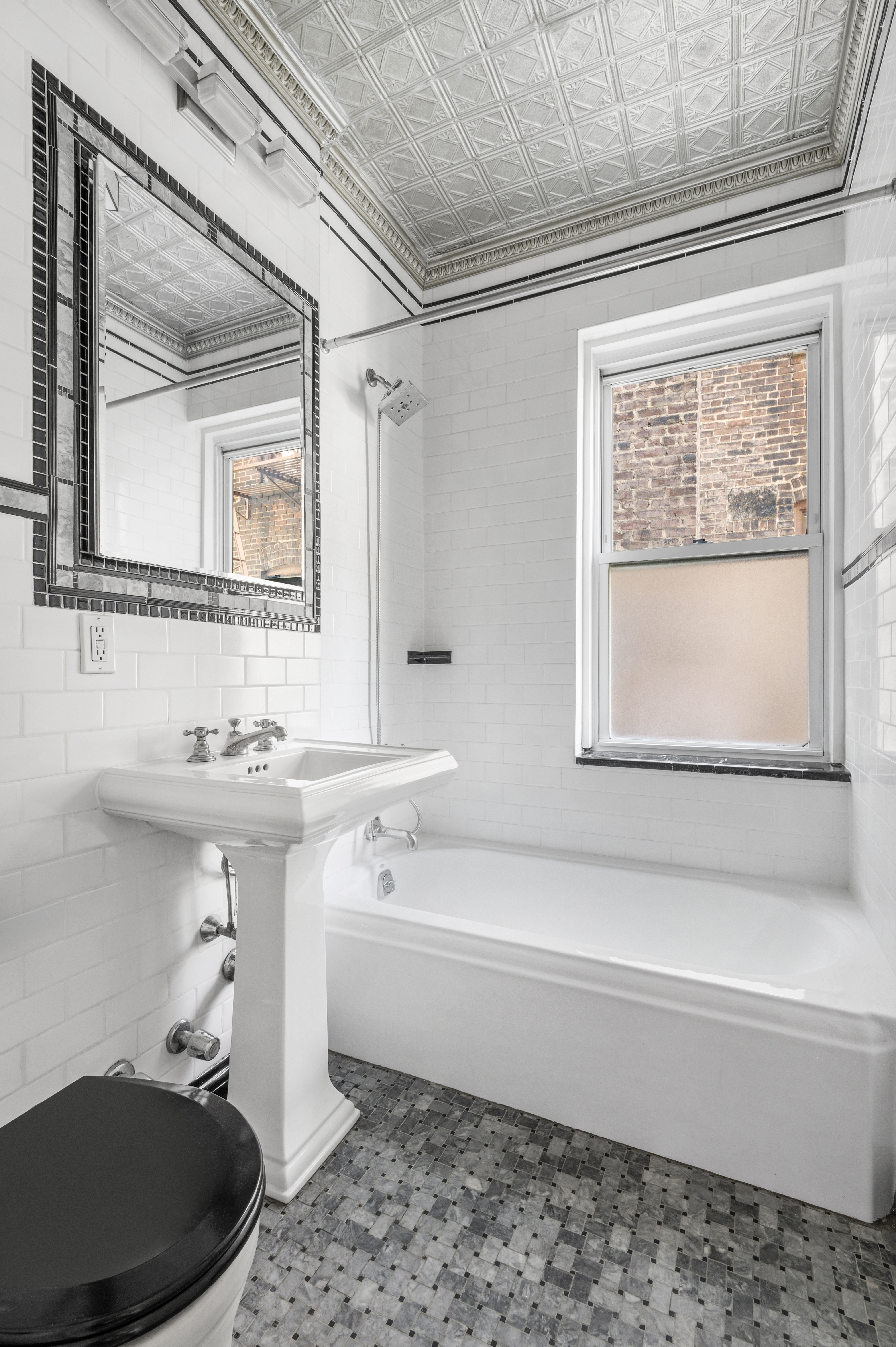 306 West 4th Street, Unit D3 Manhattan, NY 10014 - Photo 6 of 9 a bathroom with a sink a toilet and a bathtub