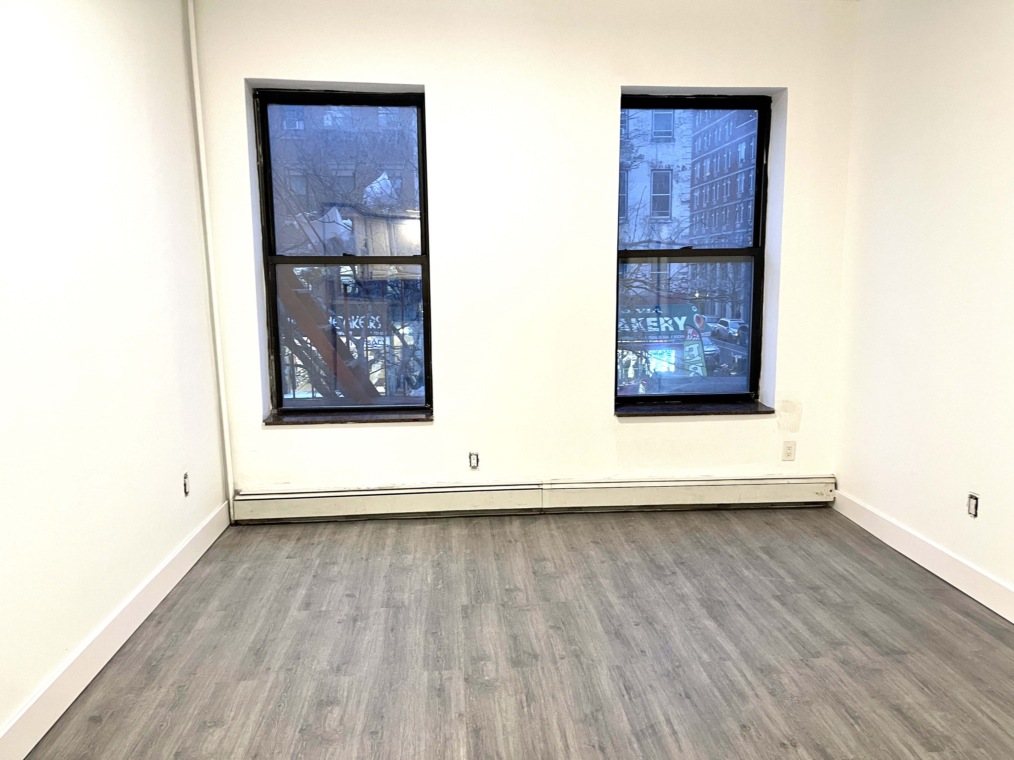 1999 3rd Avenue, Unit 1 Manhattan, NY 10029 - Photo 12 of 23 a view of an empty room and wooden floor
