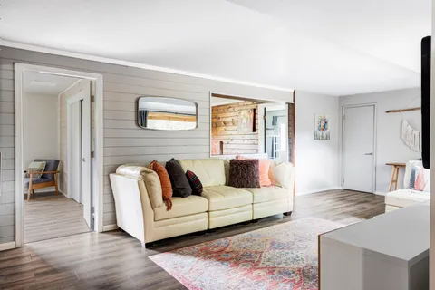 a living room with furniture and a rug