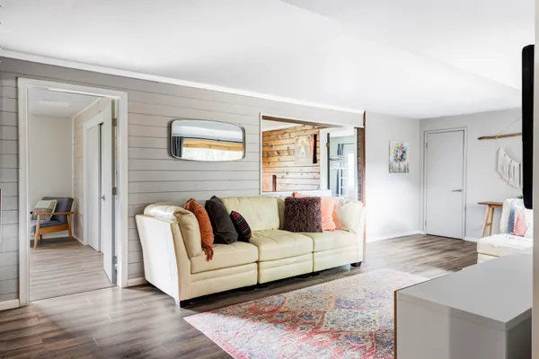 a living room with furniture and a rug