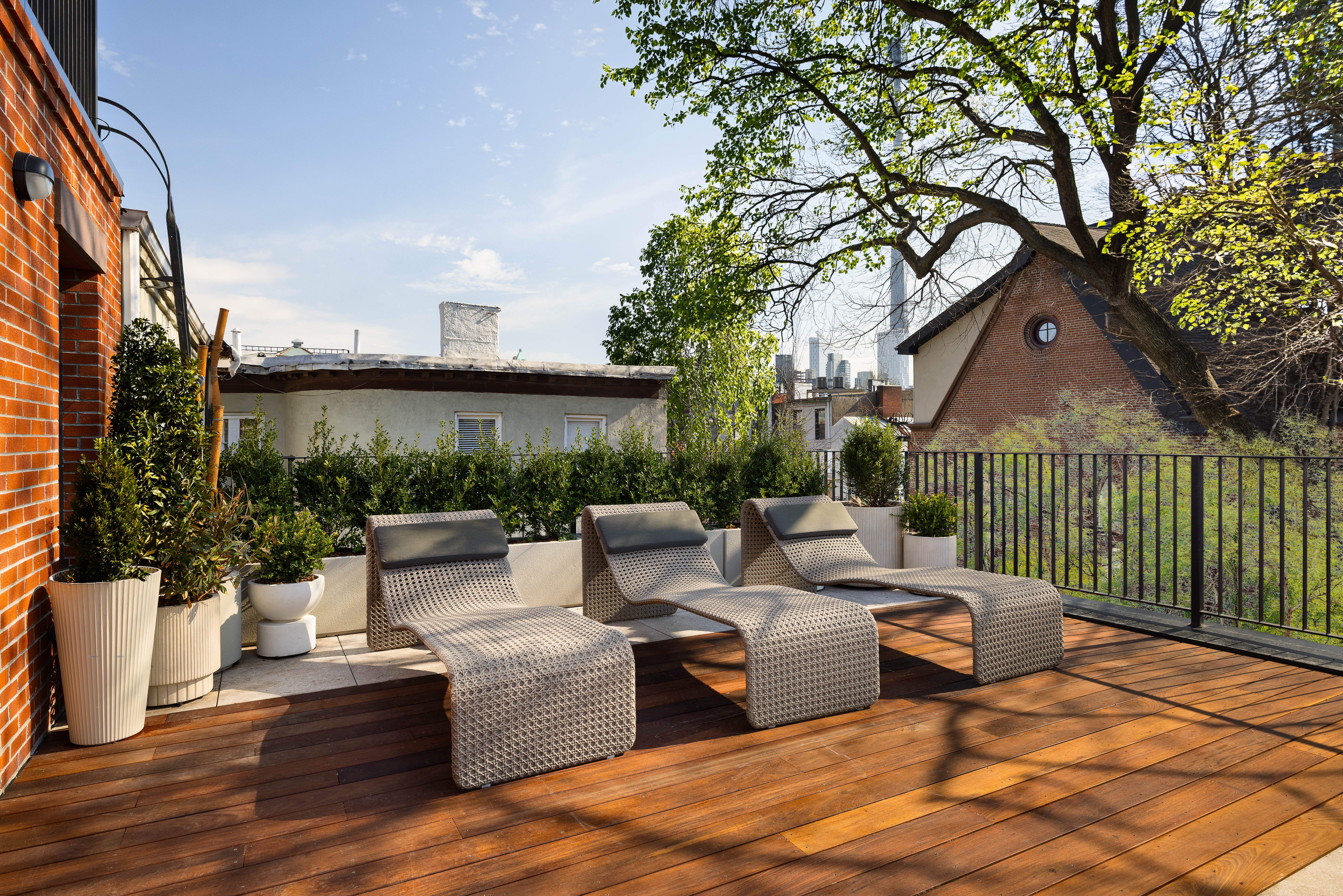 487 Henry Street Brooklyn, NY 11231 - Photo 21 of 37 a view of a patio with couches chairs potted plants and wooden fence