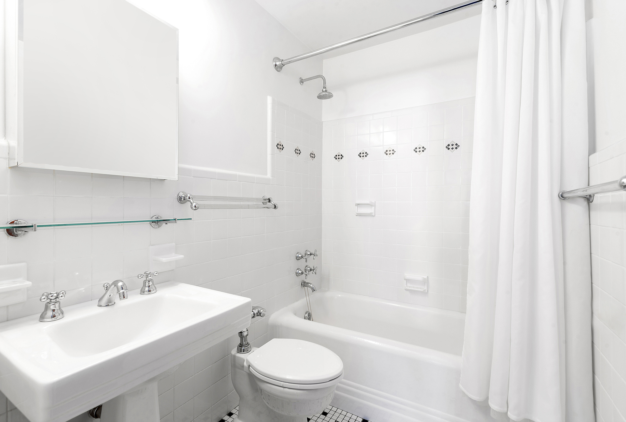 302 West 12th Street, Unit 12C Manhattan, NY 10014 - Photo 7 of 13 a bathroom with a sink a toilet and shower