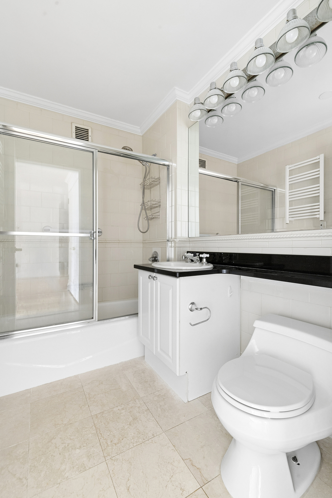 404 East 76th Street, Unit 4E Manhattan, NY 10021 - Photo 5 of 6 a bathroom with a sink a toilet and a mirror