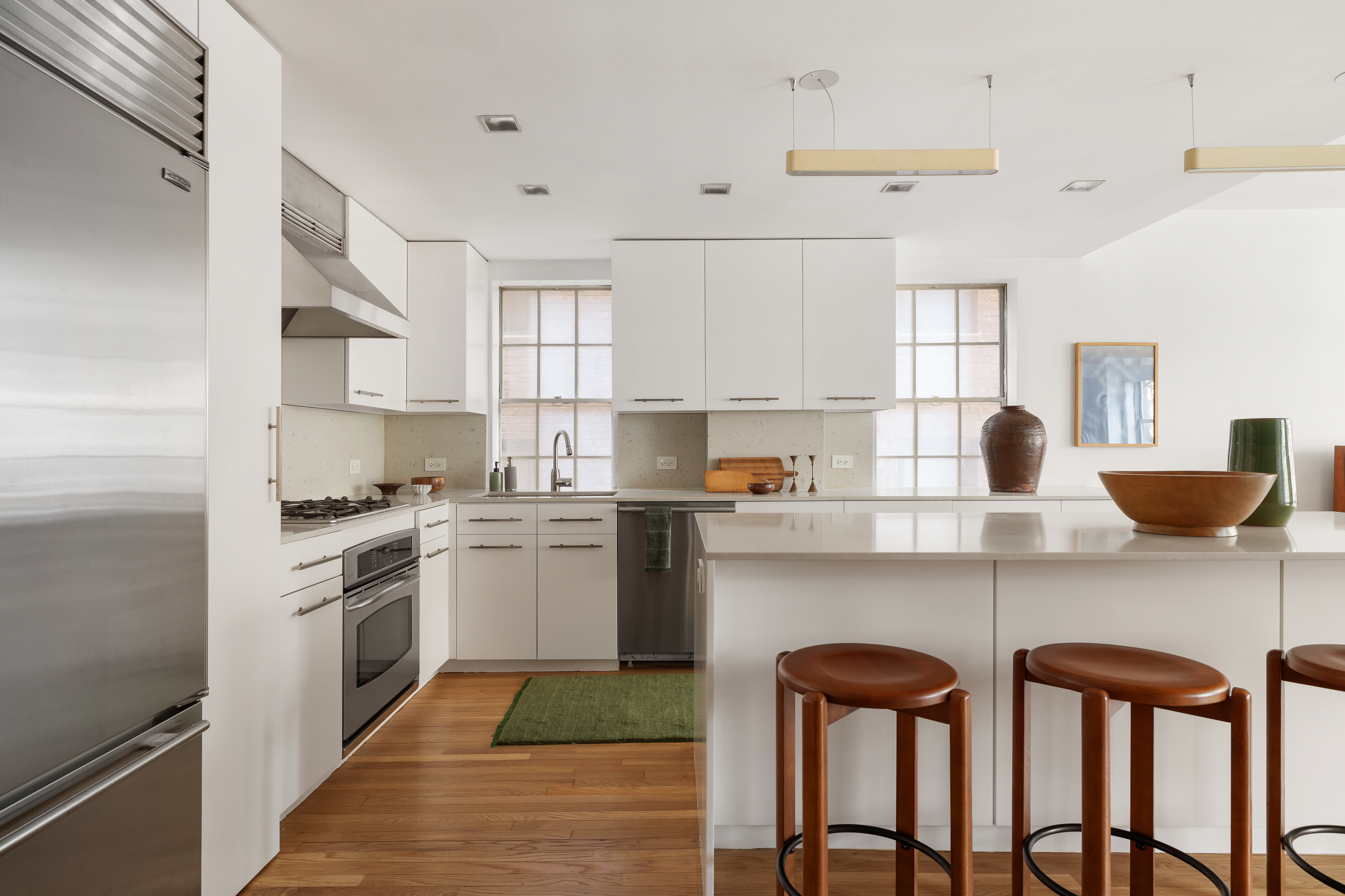 2 Horatio Street, Unit 2PR Manhattan, NY 10014 - Photo 4 of 14 a kitchen with stainless steel appliances granite countertop a table chairs sink and cabinets
