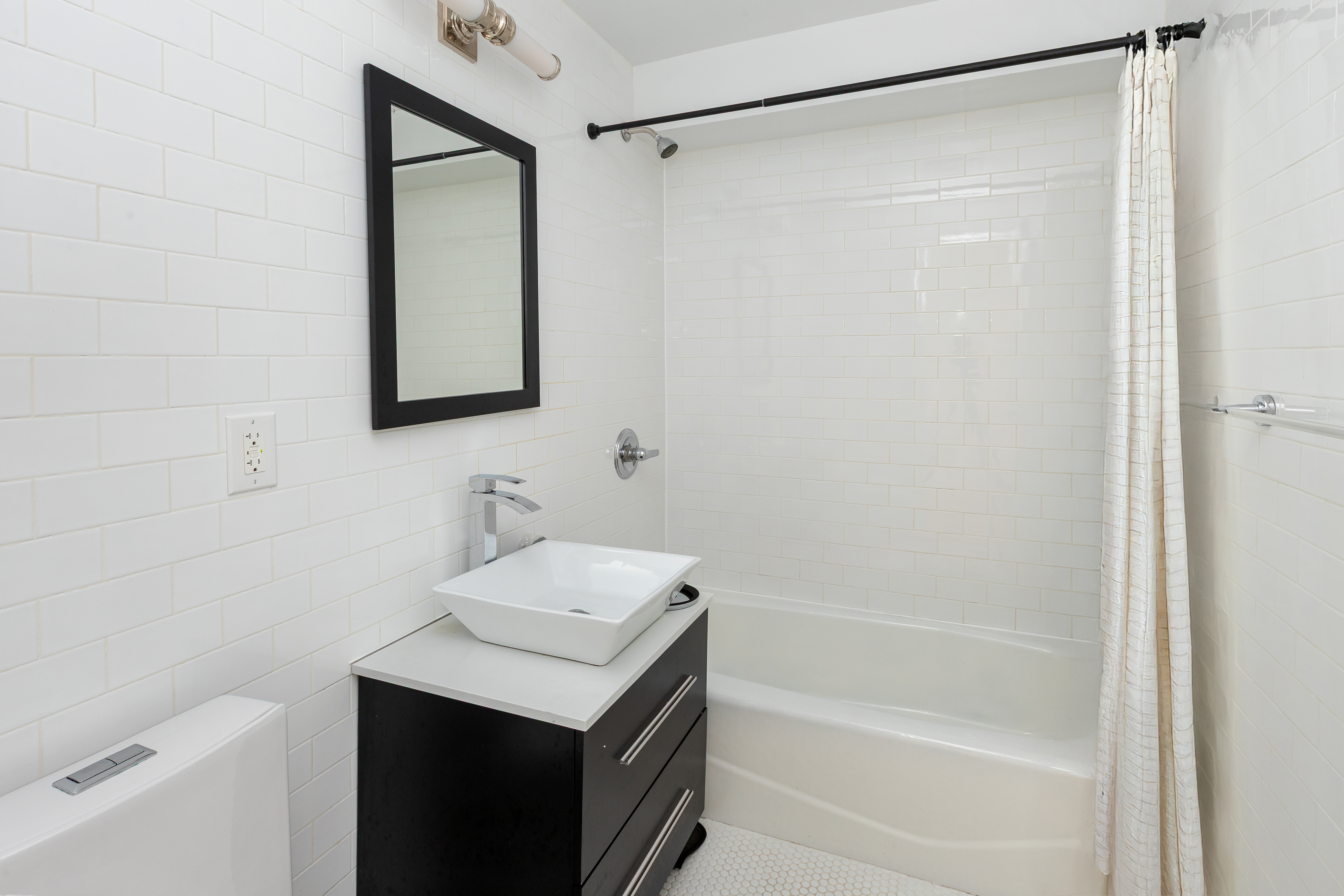 492 Warren Street, Unit GARDEN Brooklyn, NY 11217 - Photo 6 of 8 a bathroom with a shower curtain and a sink