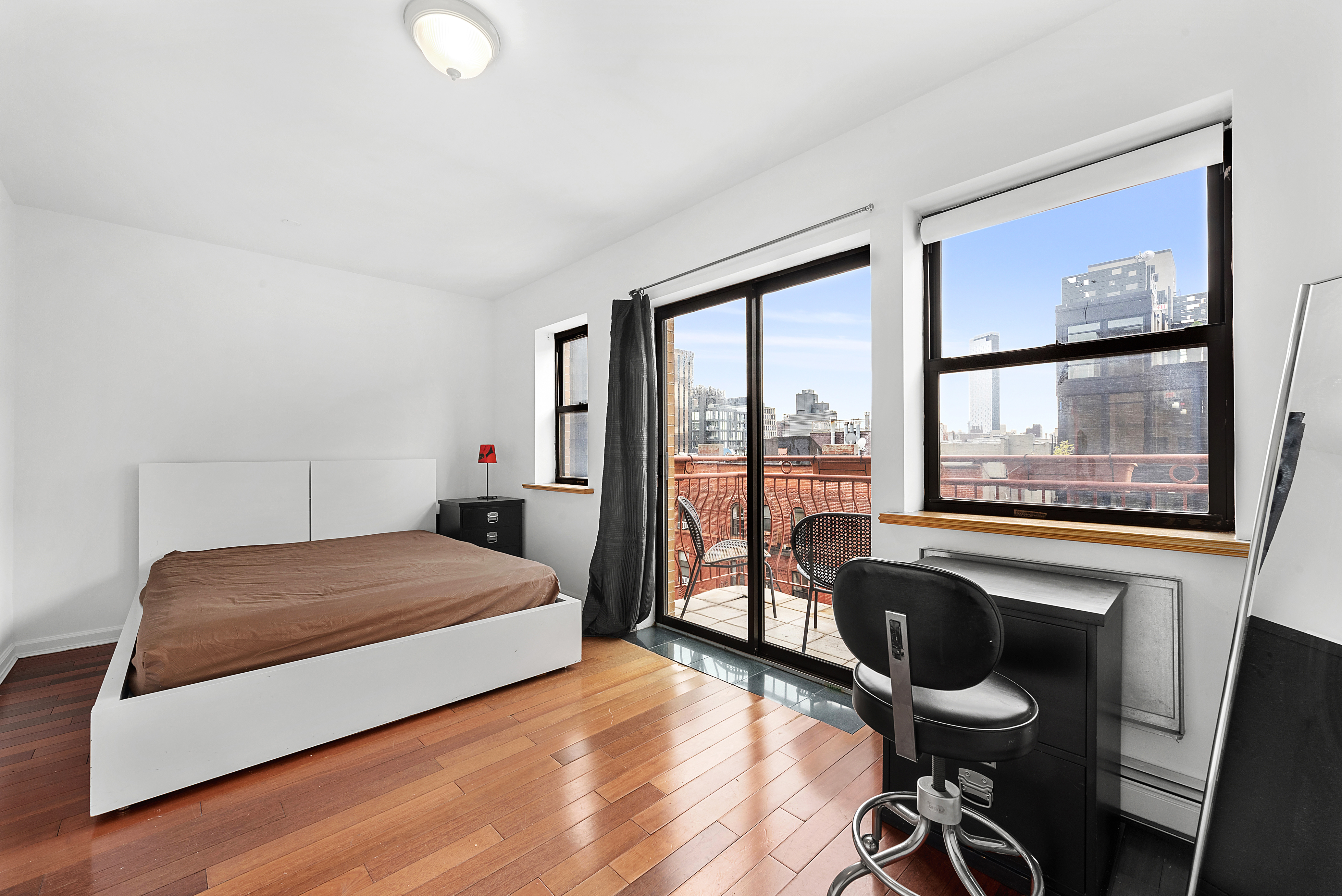 62 Rivington Street, Unit 9A Manhattan, NY 10002 - Photo 4 of 6 a bedroom with a bed and a window