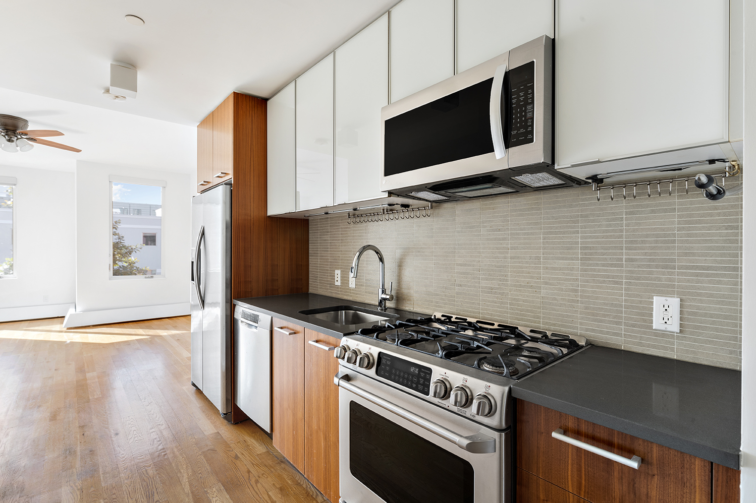 a kitchen with stainless steel appliances a sink a stove and cabinets