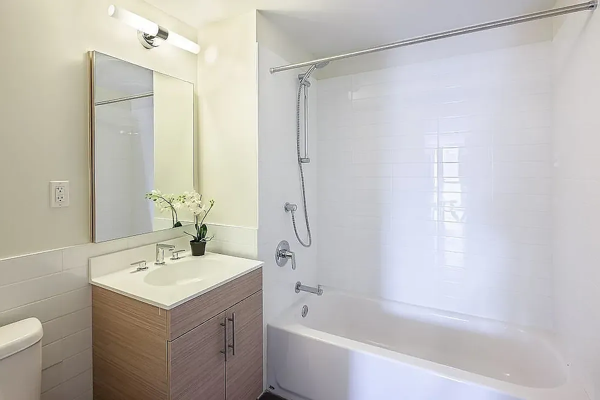 44-72 11th Street, Unit B302 Queens, NY 11101 - Photo 4 of 12 a bathroom with a sink mirror toilet and shower