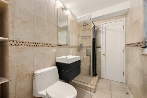 a bathroom with a toilet and a shower