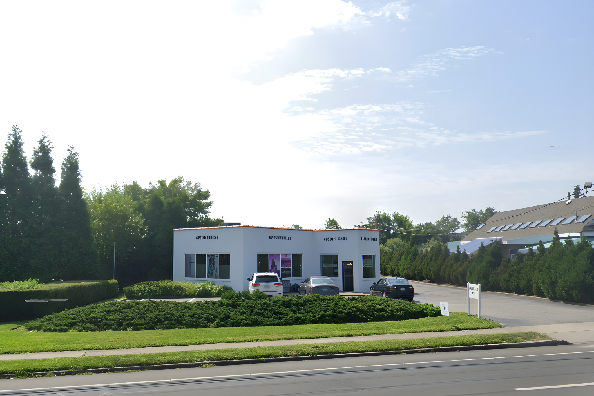 a view of a house with a big yard plants and large trees