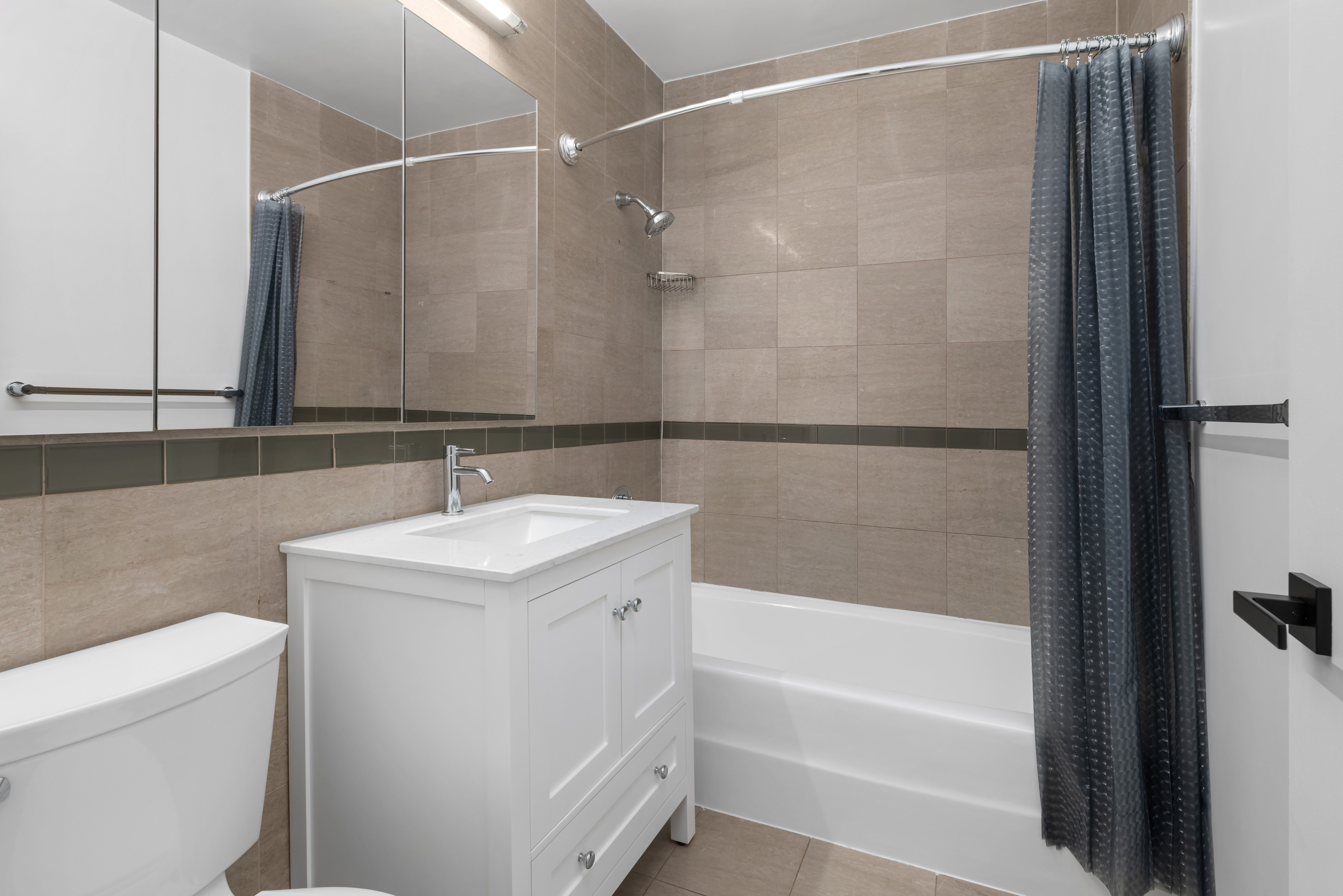 212 East 57th Street, Unit 3B Manhattan, NY 10022 - Photo 8 of 17 a bathroom with a sink and a bathtub