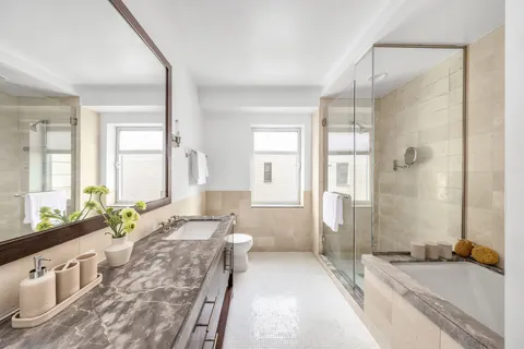 a spacious bathroom with sink shower and a bathtub