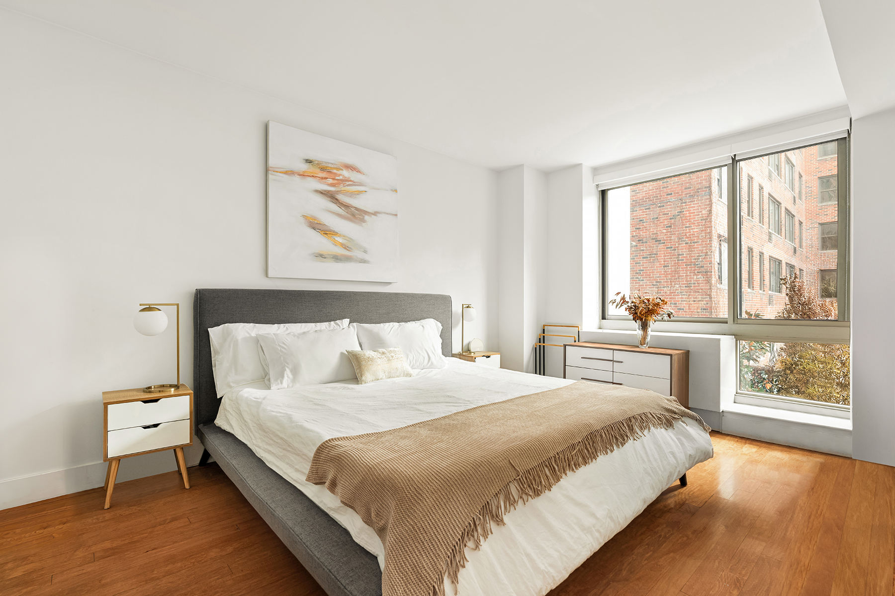 242 East 25th Street, Unit 3A Manhattan, NY 10010 - Photo 4 of 9 a bedroom with a large bed and a large window