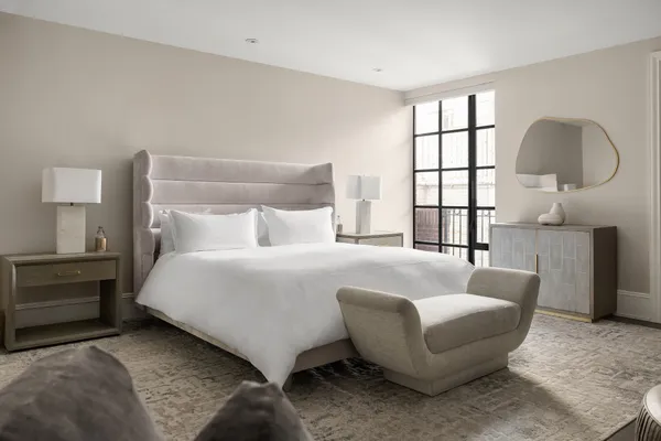 a bedroom with a bed window and flat screen tv