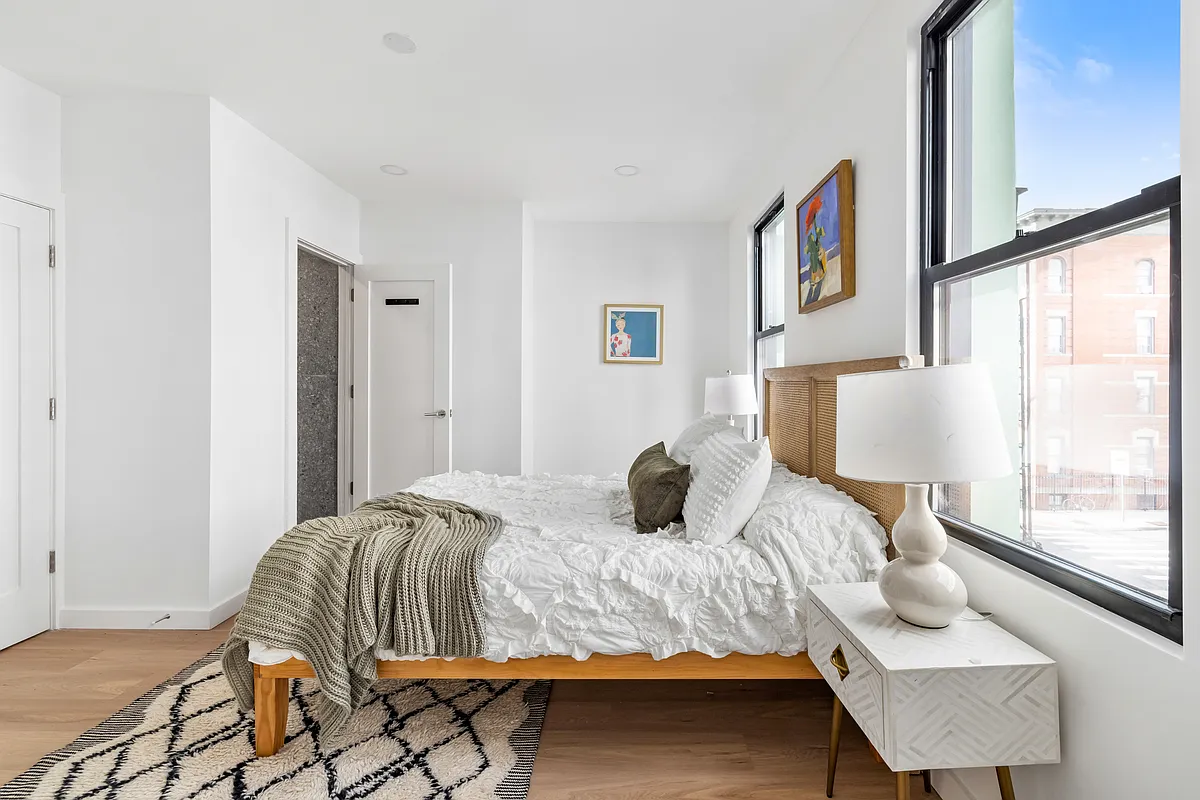 76 Meserole Avenue, Unit 2A Brooklyn, NY 11222 - Photo 8 of 10 a bedroom with a bed and a window