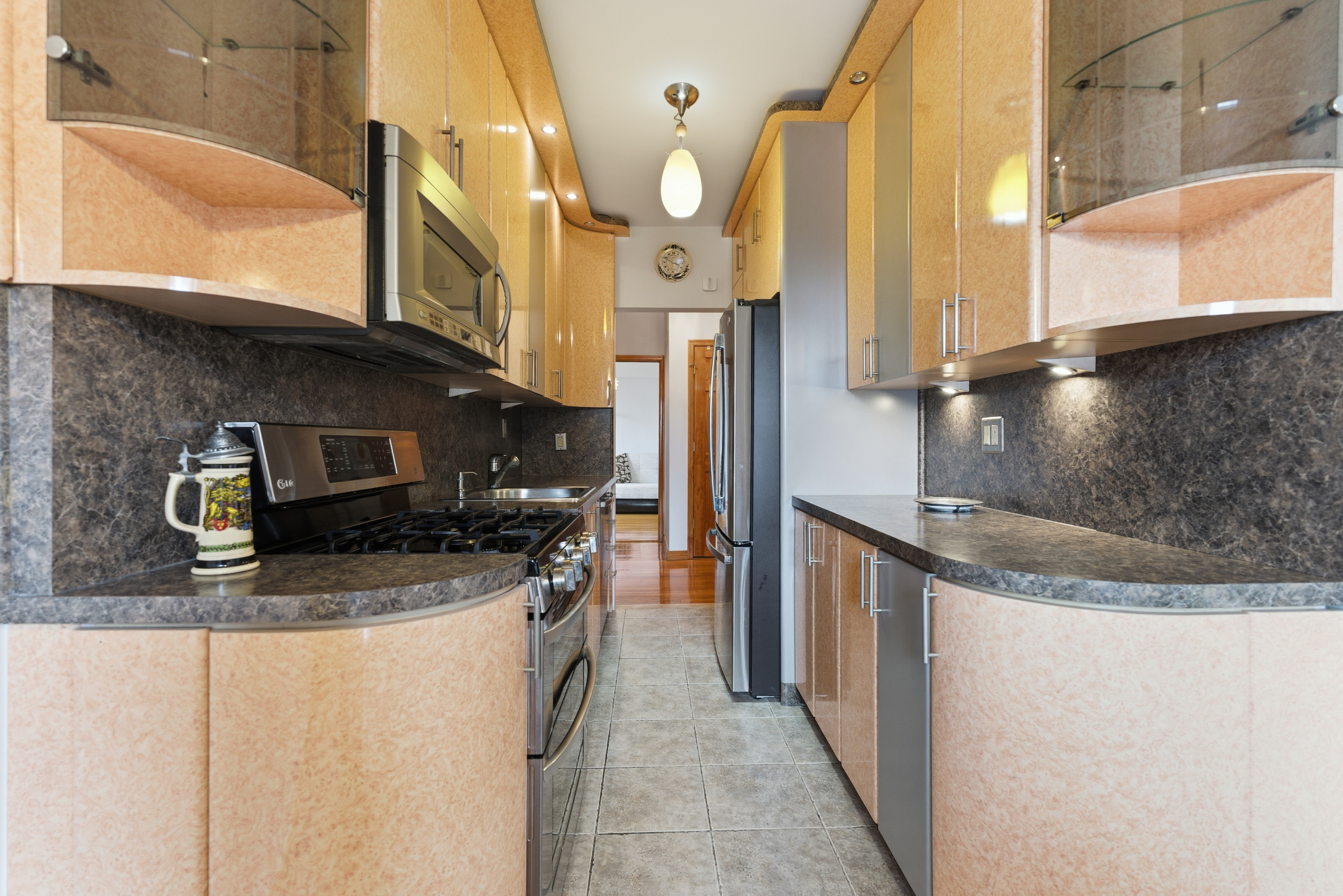 3616 Henry Hudson Parkway, Unit 7GN Bronx, NY 10463 - Photo 7 of 17 a kitchen with stainless steel appliances granite countertop a sink a stove and a refrigerator