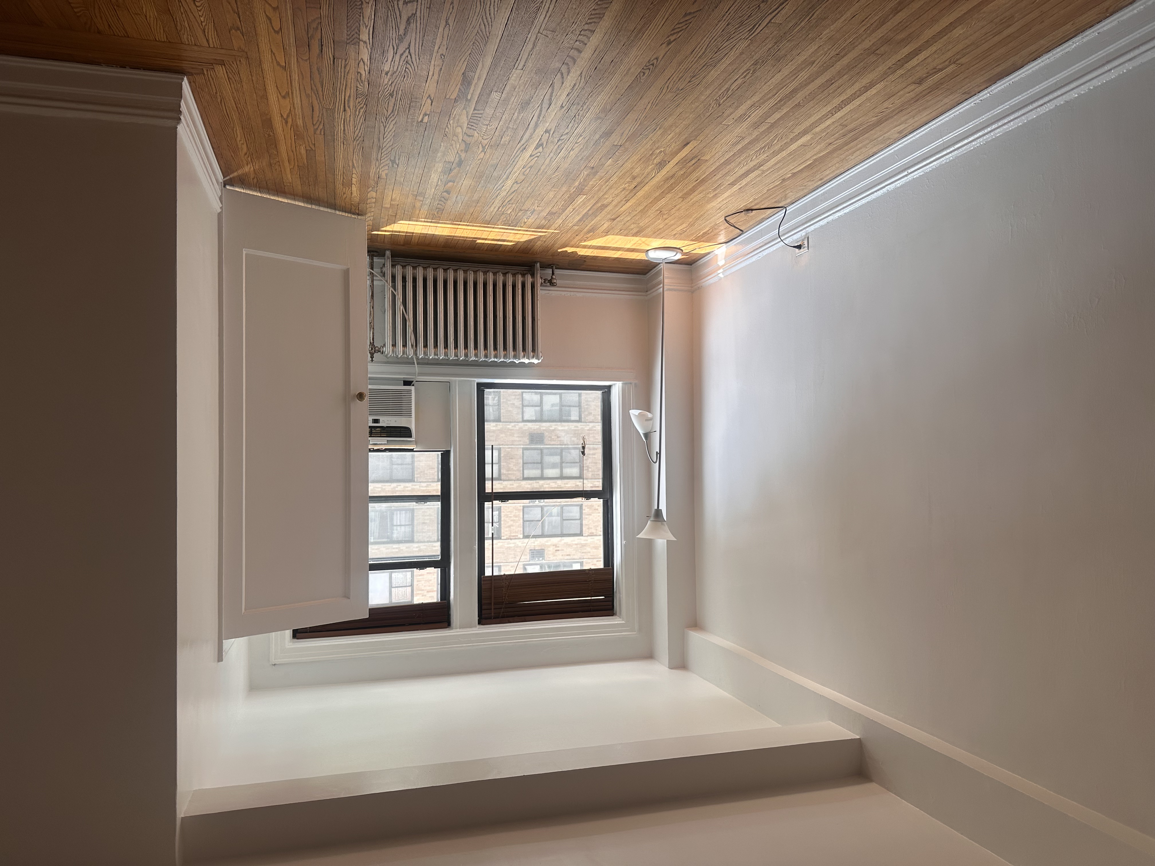 457 West 57th Street, Unit 505 Manhattan, NY 10019 - Photo 5 of 10 a view of an empty room with wooden floor