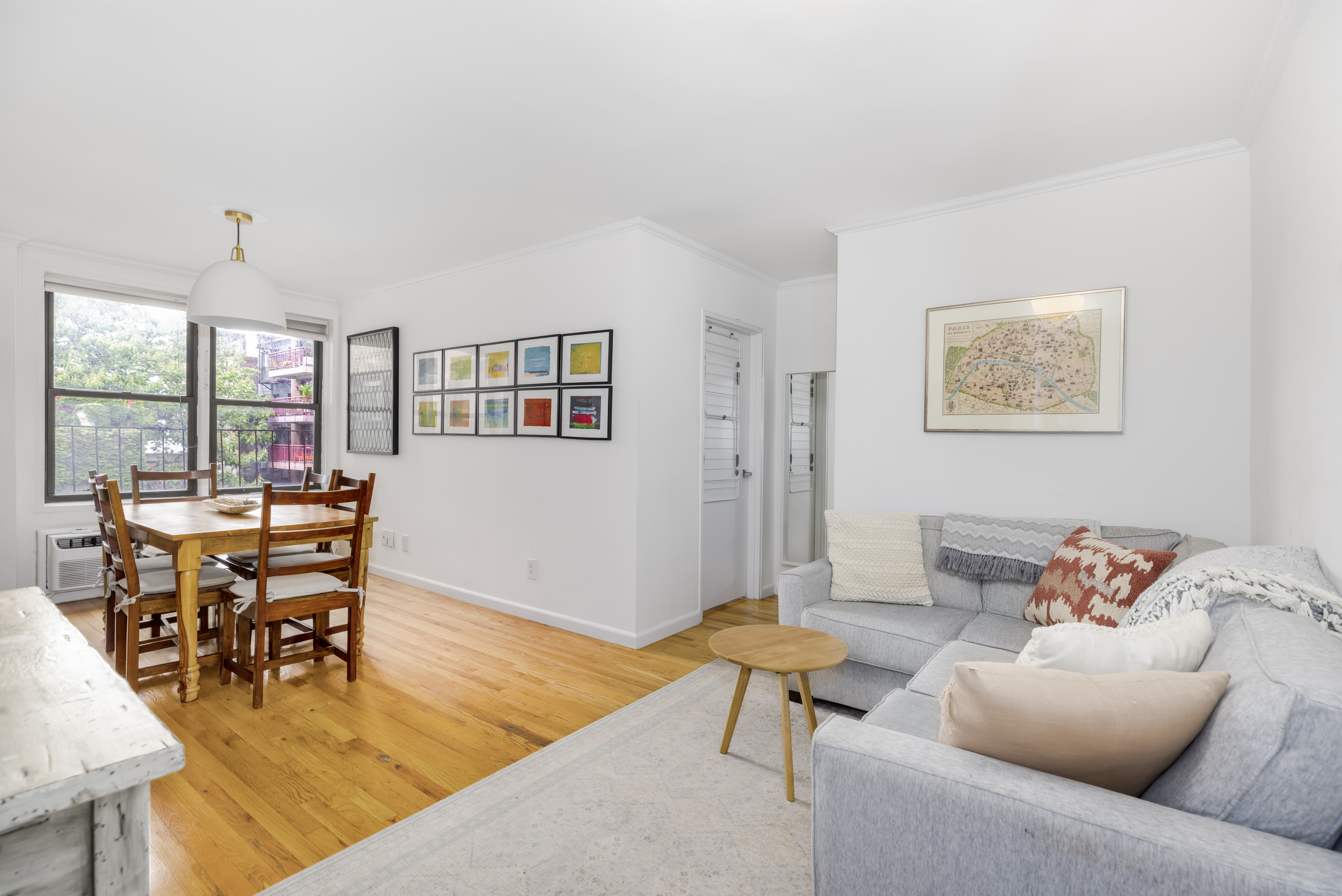 a living room with furniture and a dining table with kitchen view