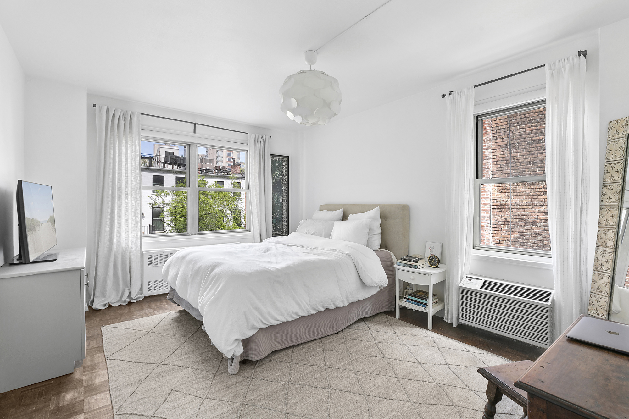 1199 Park Avenue, Unit 2F Manhattan, NY 10128 - Photo 7 of 12 a bedroom with a bed and a window