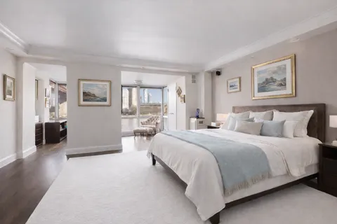 a spacious bedroom with a bed and a large mirror