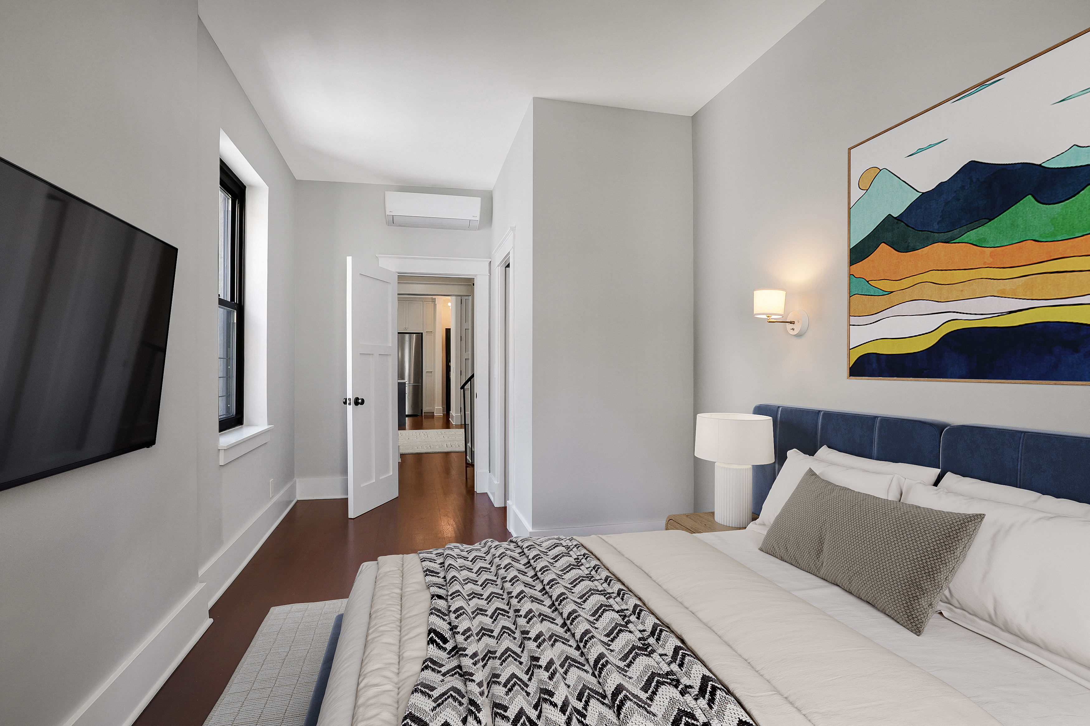 133 East 30th Street, Unit PH5B Manhattan, NY 10016 - Photo 6 of 24 a bedroom with a bed and a flat screen tv