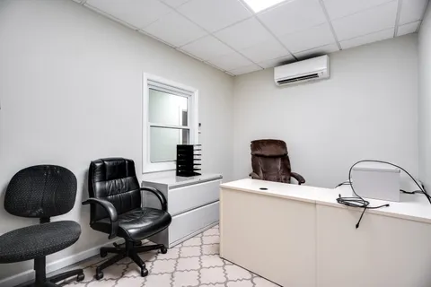 a spacious bedroom with a bed and a window