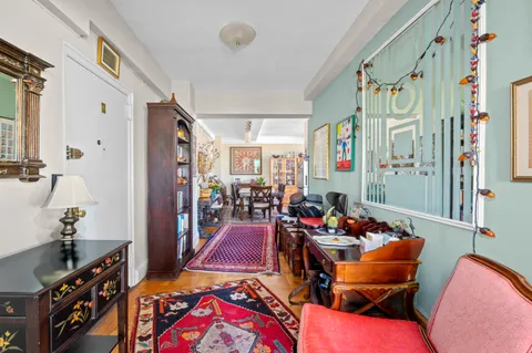 a living room with furniture and a chandelier