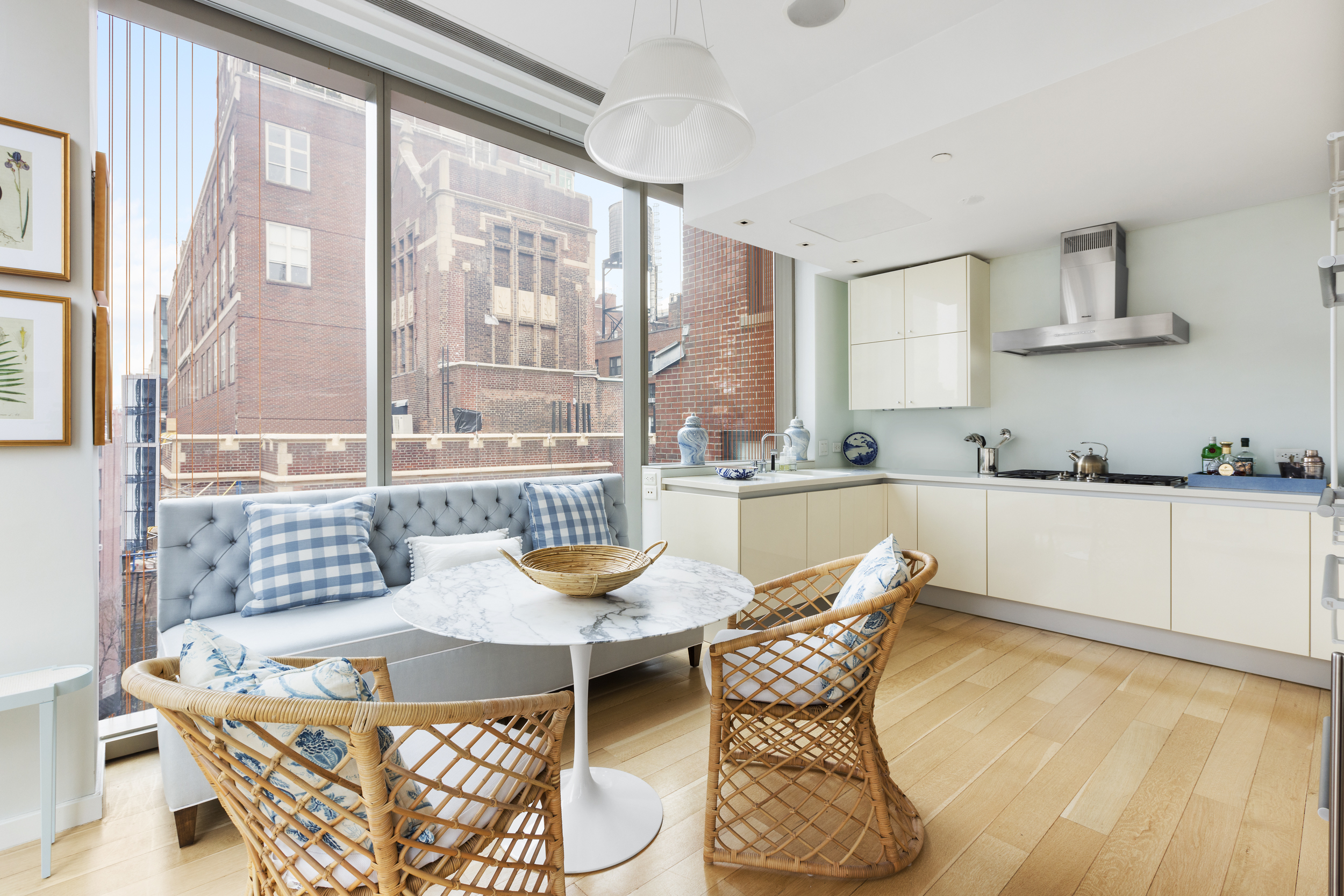 1055 Park Avenue, Unit PH Manhattan, NY 10028 - Photo 7 of 19 a dining room with furniture a kitchen view and chandelier