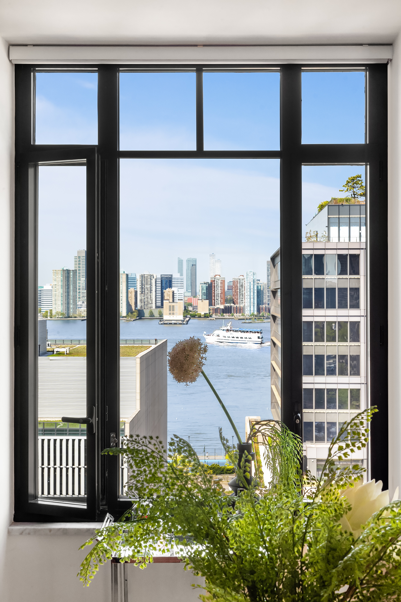 110 Charlton Street, Unit 17E Manhattan, NY 10014 - Photo 7 of 20 a view of a floor to ceiling window and wooden floor