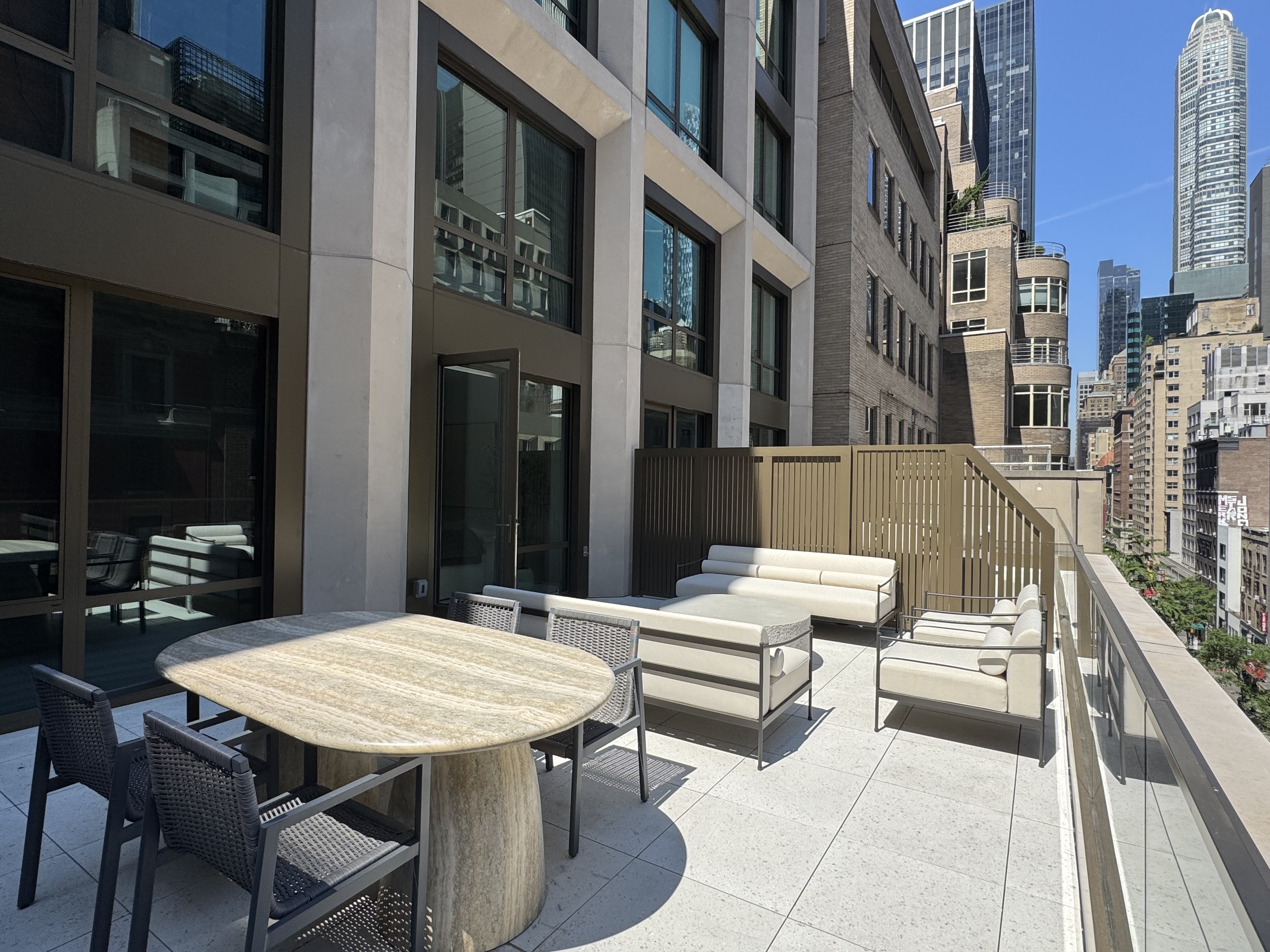 18 West 55th Street, Unit 7B Manhattan, NY 10019 - Photo 2 of 20 a view of a dinning tables and chairs in a patio