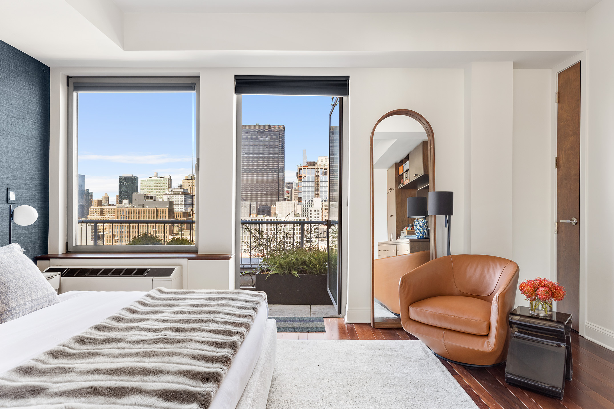 252 7th Avenue, Unit PHG Manhattan, NY 10001 - Photo 14 of 27 a bedroom with a bed and a large window