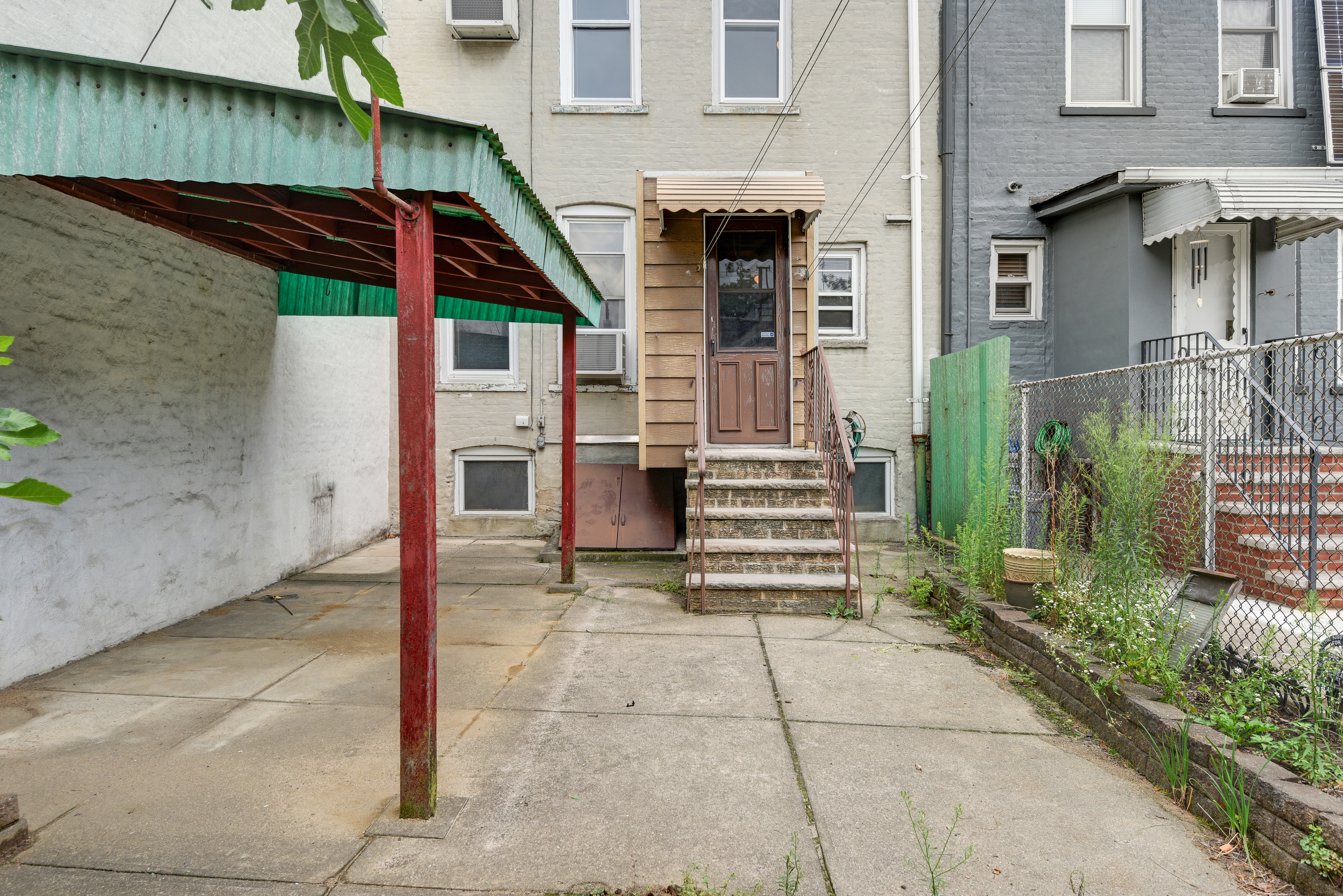 75-36 60th Lane Queens, NY 11385 - Photo 16 of 18 a view of a house with a door and wooden walls