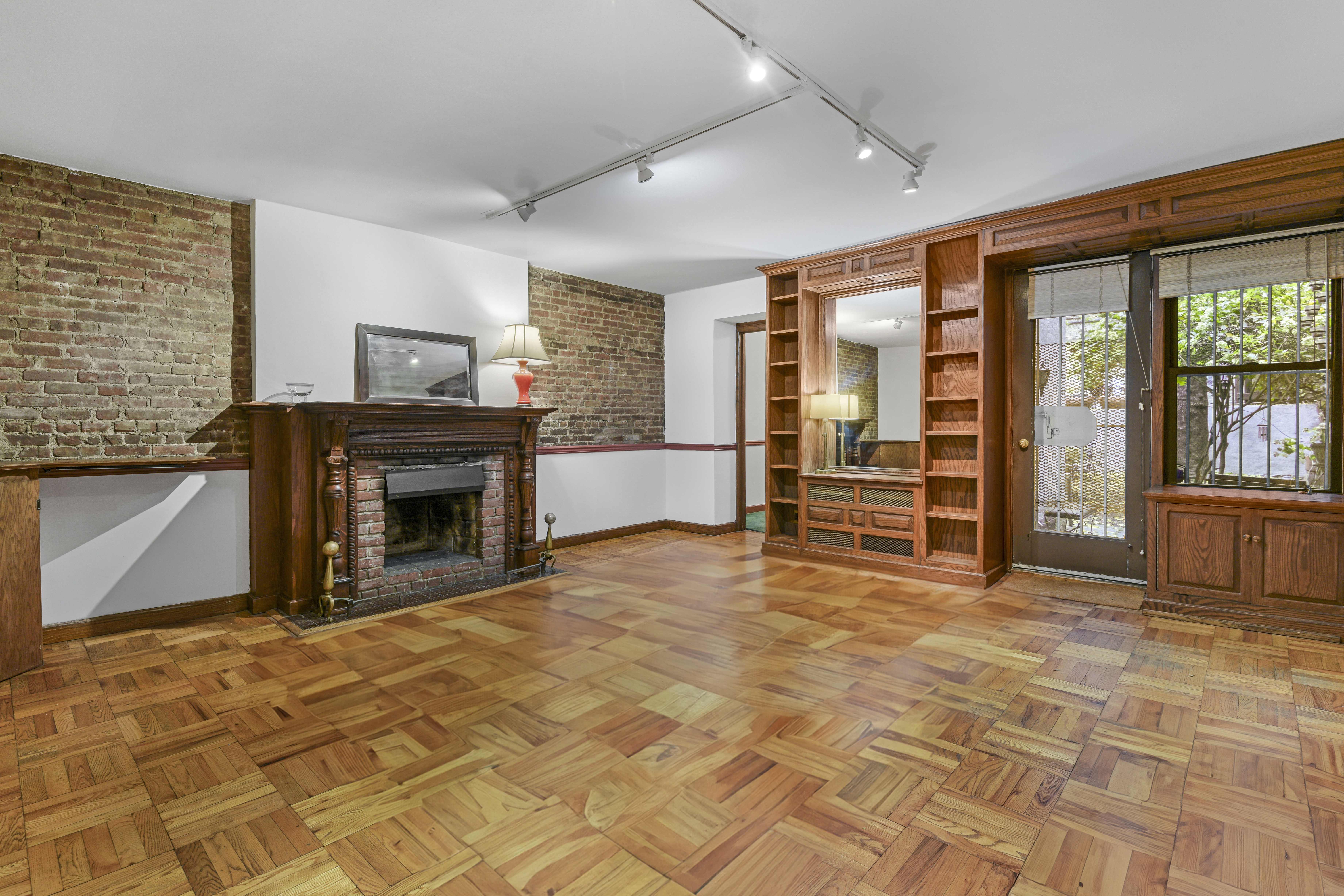 146 West 80th Street, Unit BR Manhattan, NY 10024 - Photo 11 of 16 a view of an empty room with a fireplace and a window