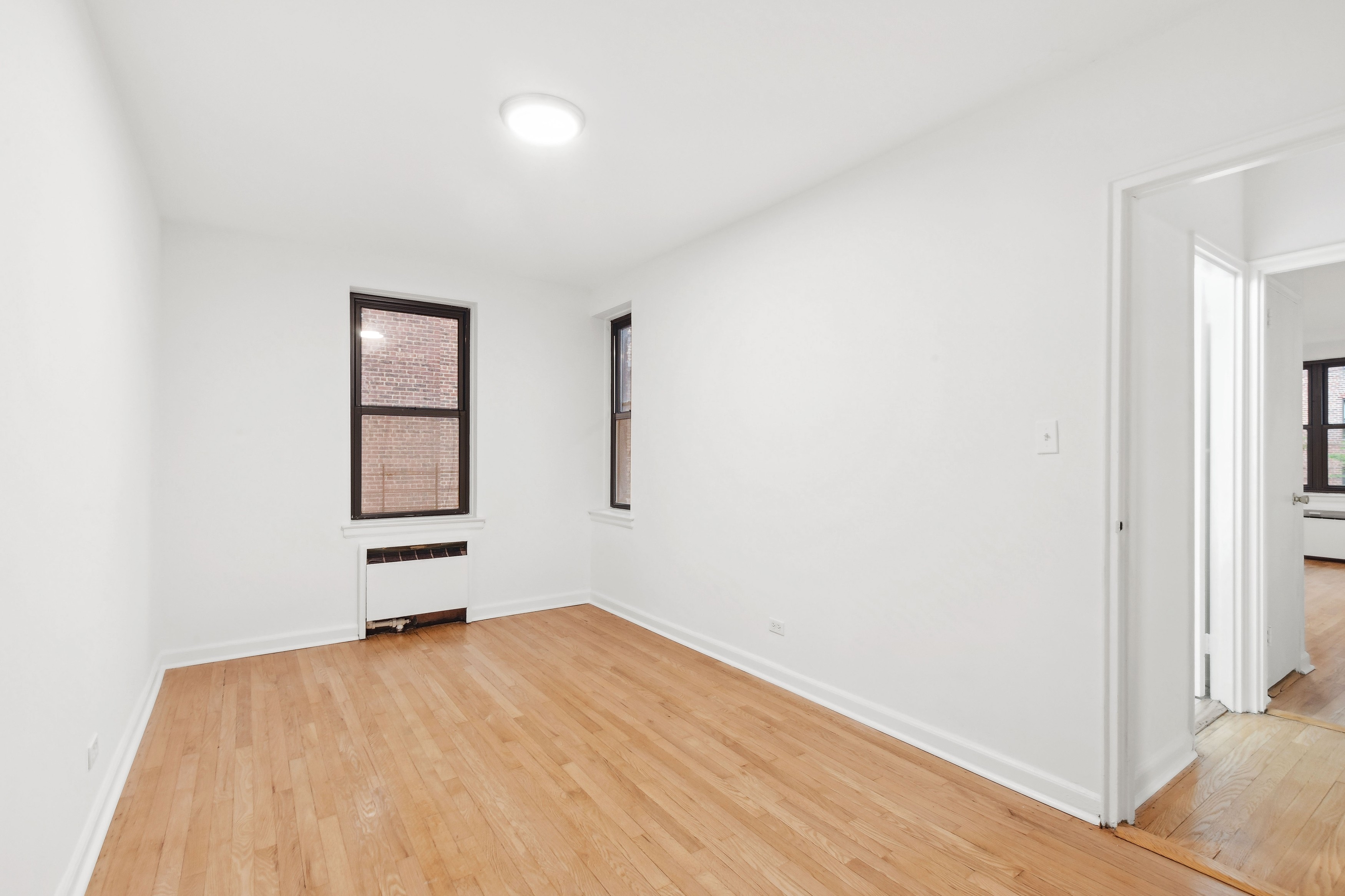 445 West 240th Street, Unit 3A Bronx, NY 10463 - Photo 4 of 8 a view of empty room with wooden floor and fan
