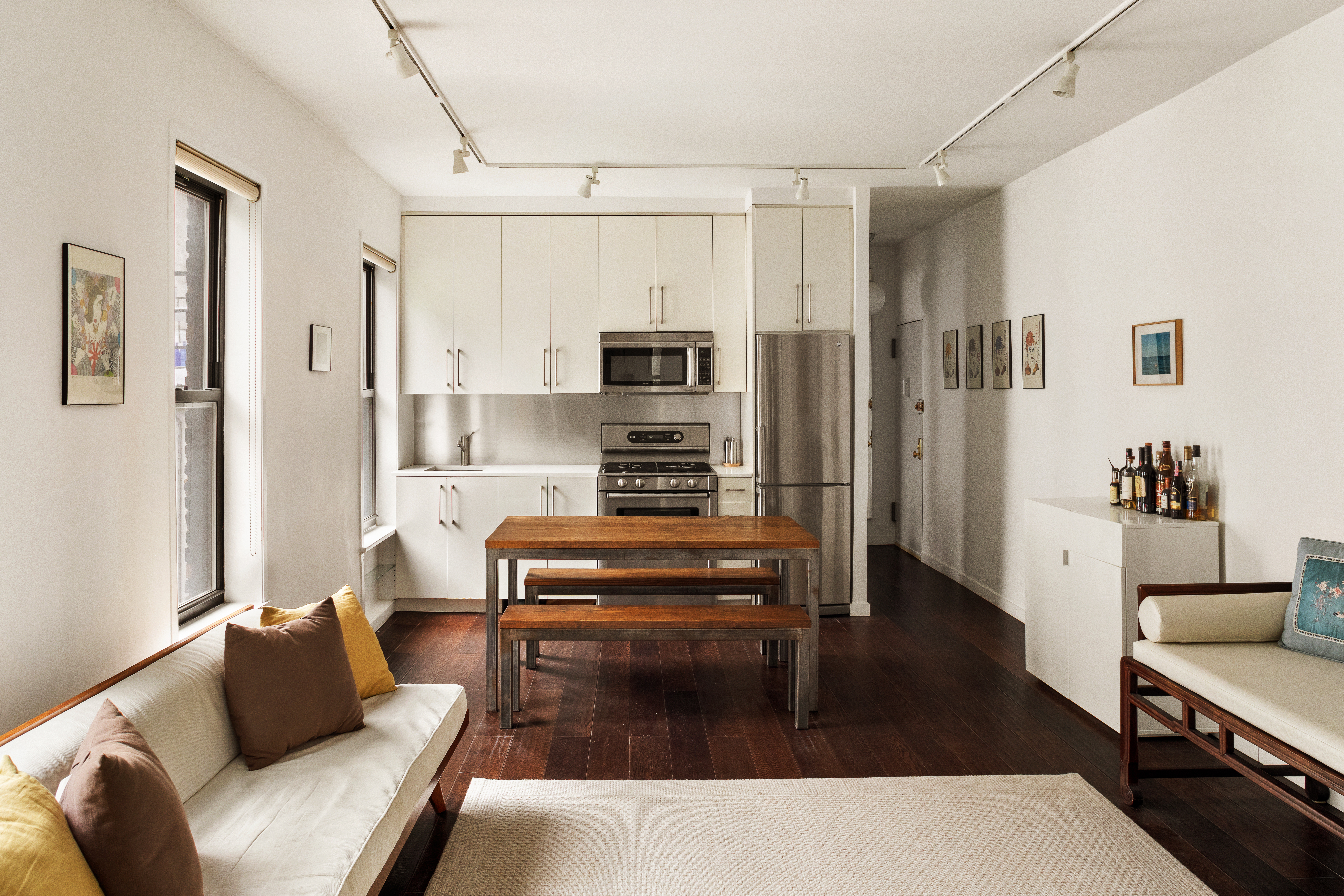 224 East 11th Street, Unit 19 Manhattan, NY 10003 - Photo 3 of 7 a living room with furniture and a wooden floor