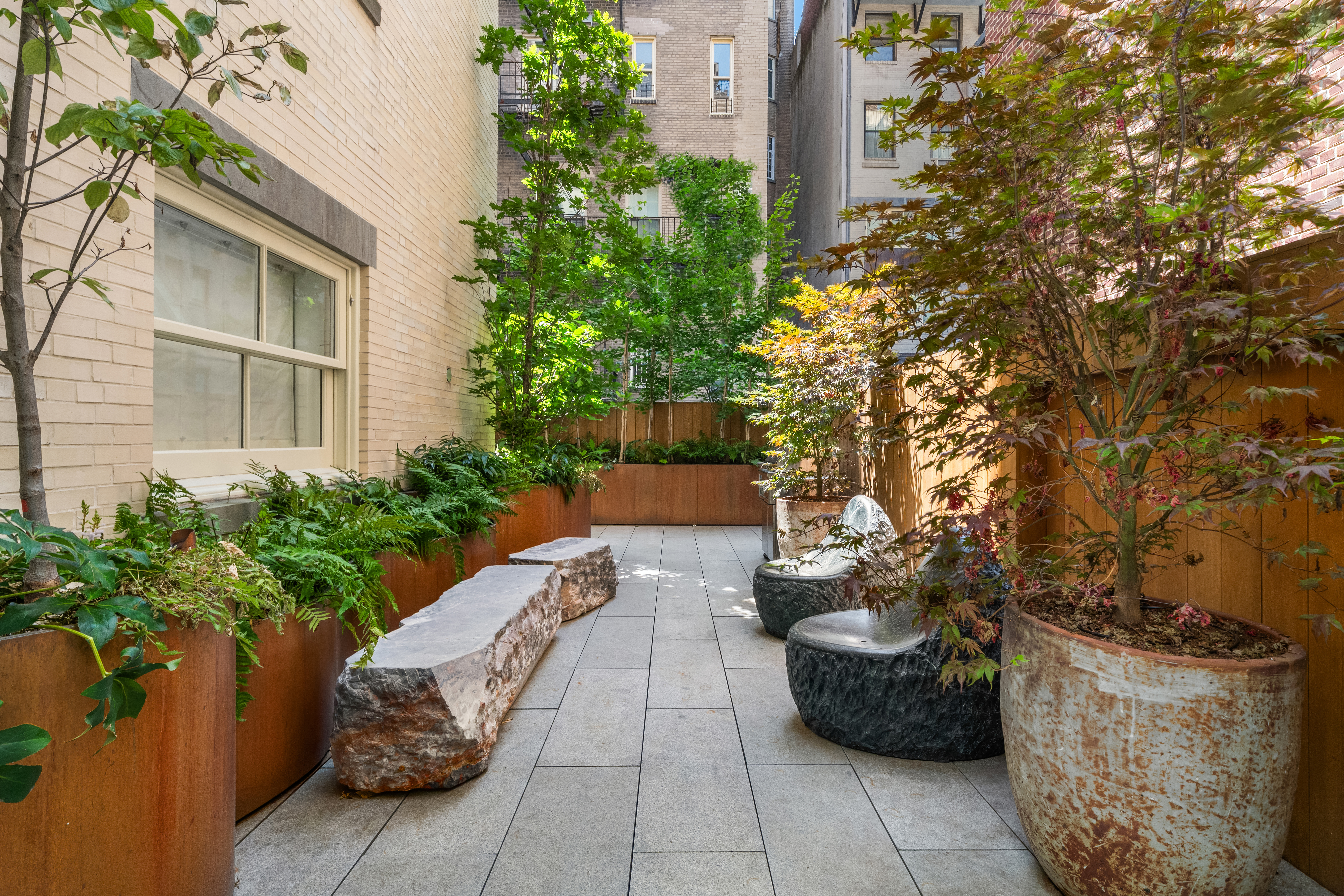 18 East 80th Street Manhattan, NY 10075 - Photo 12 of 28 a view of a patio with couches and potted plants