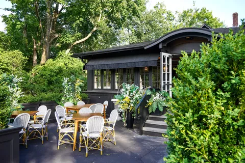 a view of a patio with table and chairs and potted plants
