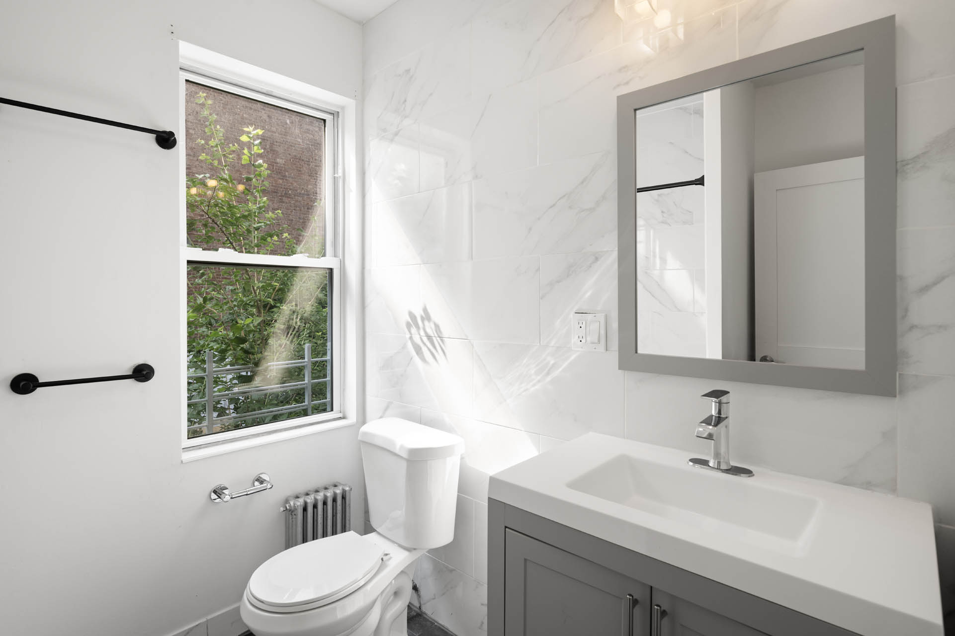 156 Summit Place, Unit 2 Bronx, NY 10463 - Photo 7 of 10 a bathroom with a sink a toilet and a window