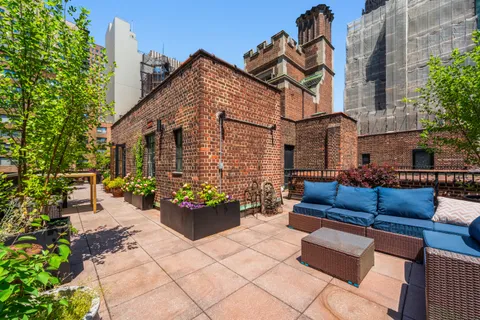 a view of a chairs and tables in the back yard of the house