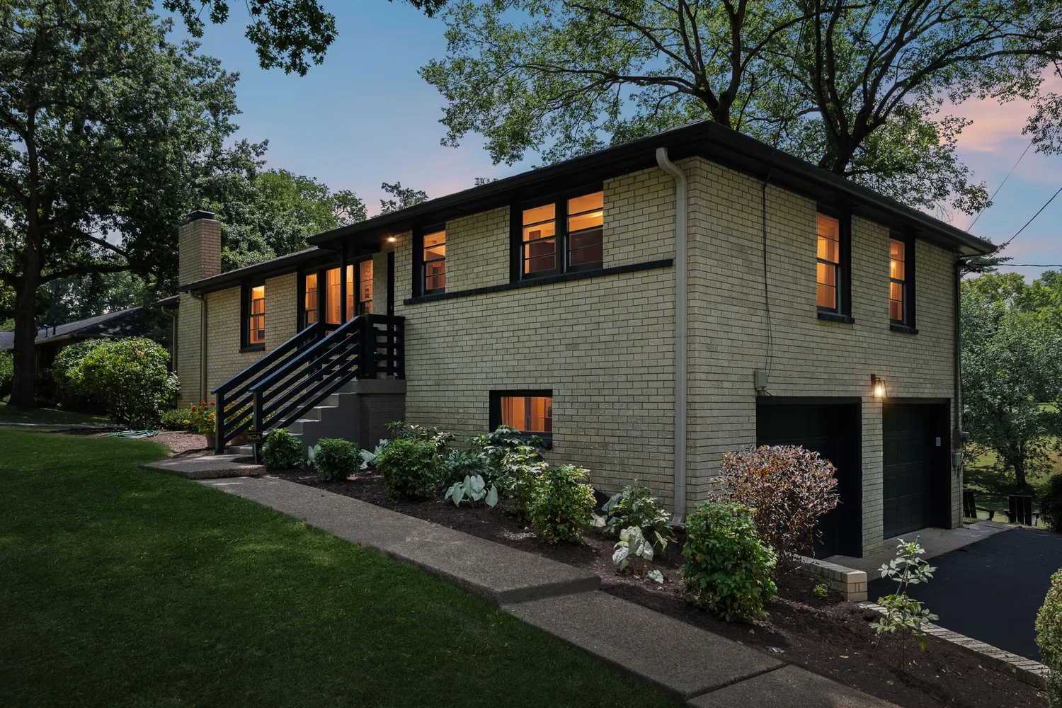 a kitchen with granite countertop a sink stainless steel appliances and cabinets