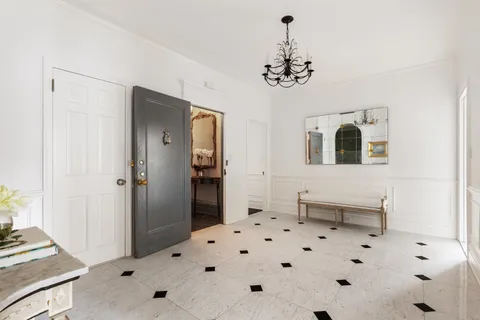 a view of a hallway with chandelier