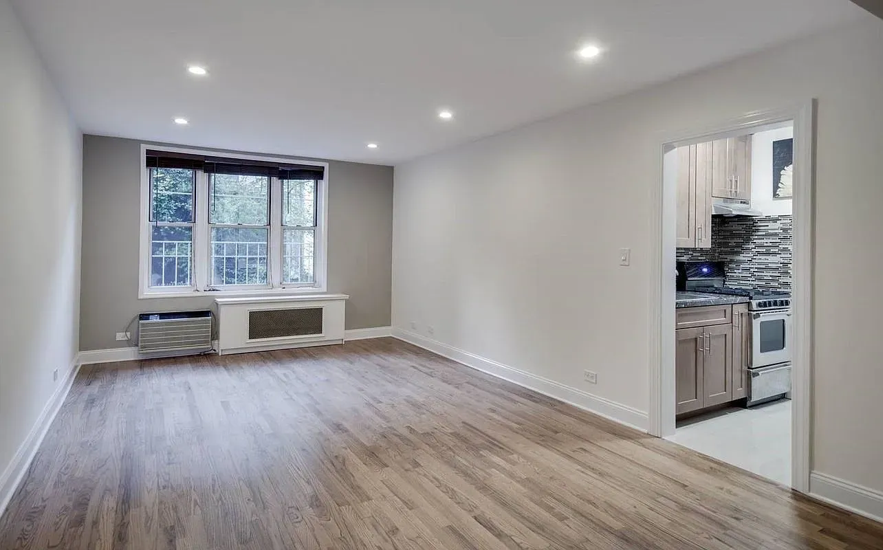 a bed room with a bed window and a mirror