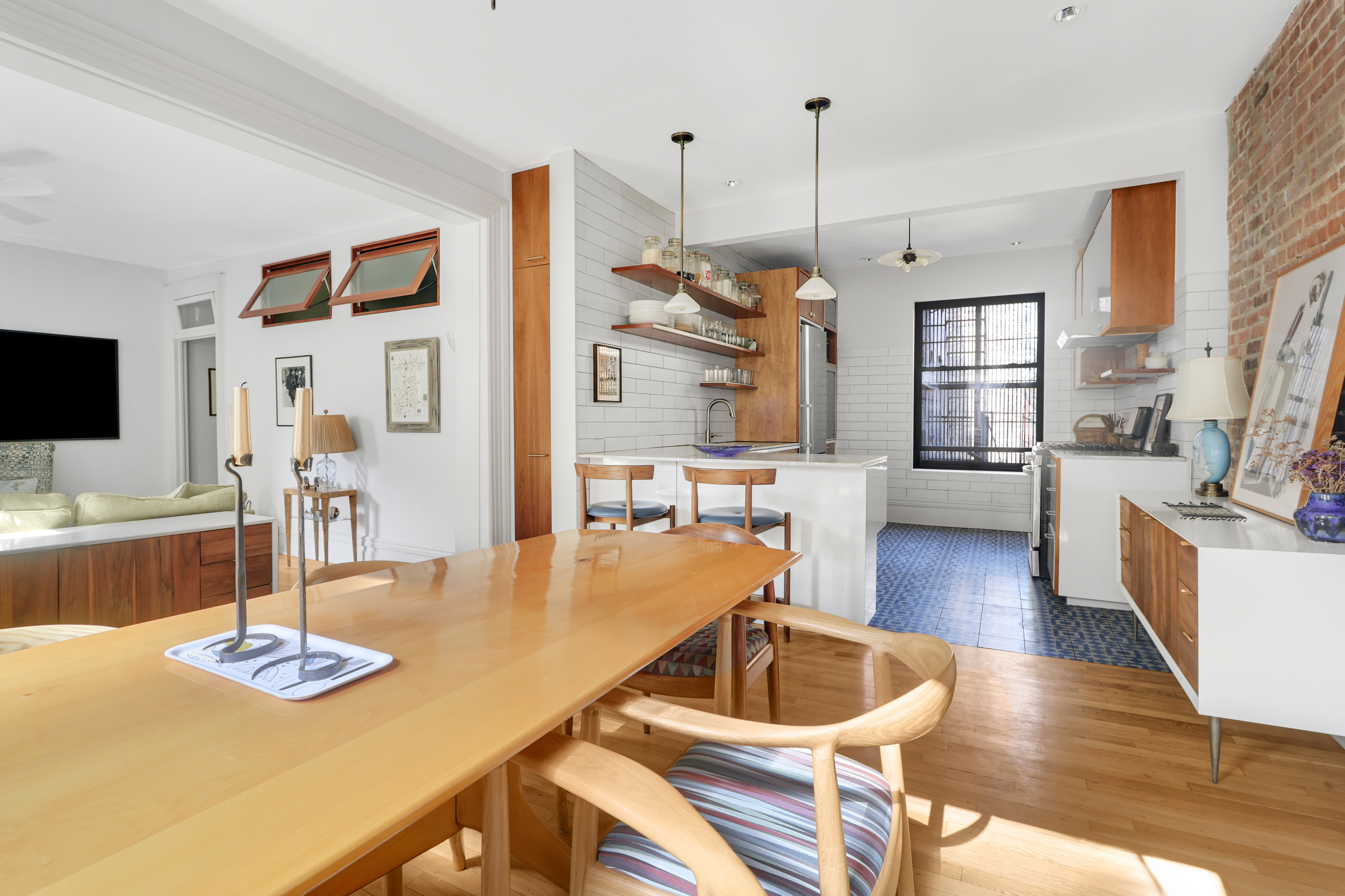 311 West 97th Street, Unit 6E Manhattan, NY 10025 - Photo 8 of 18 a living room with furniture kitchen view and a wooden floor