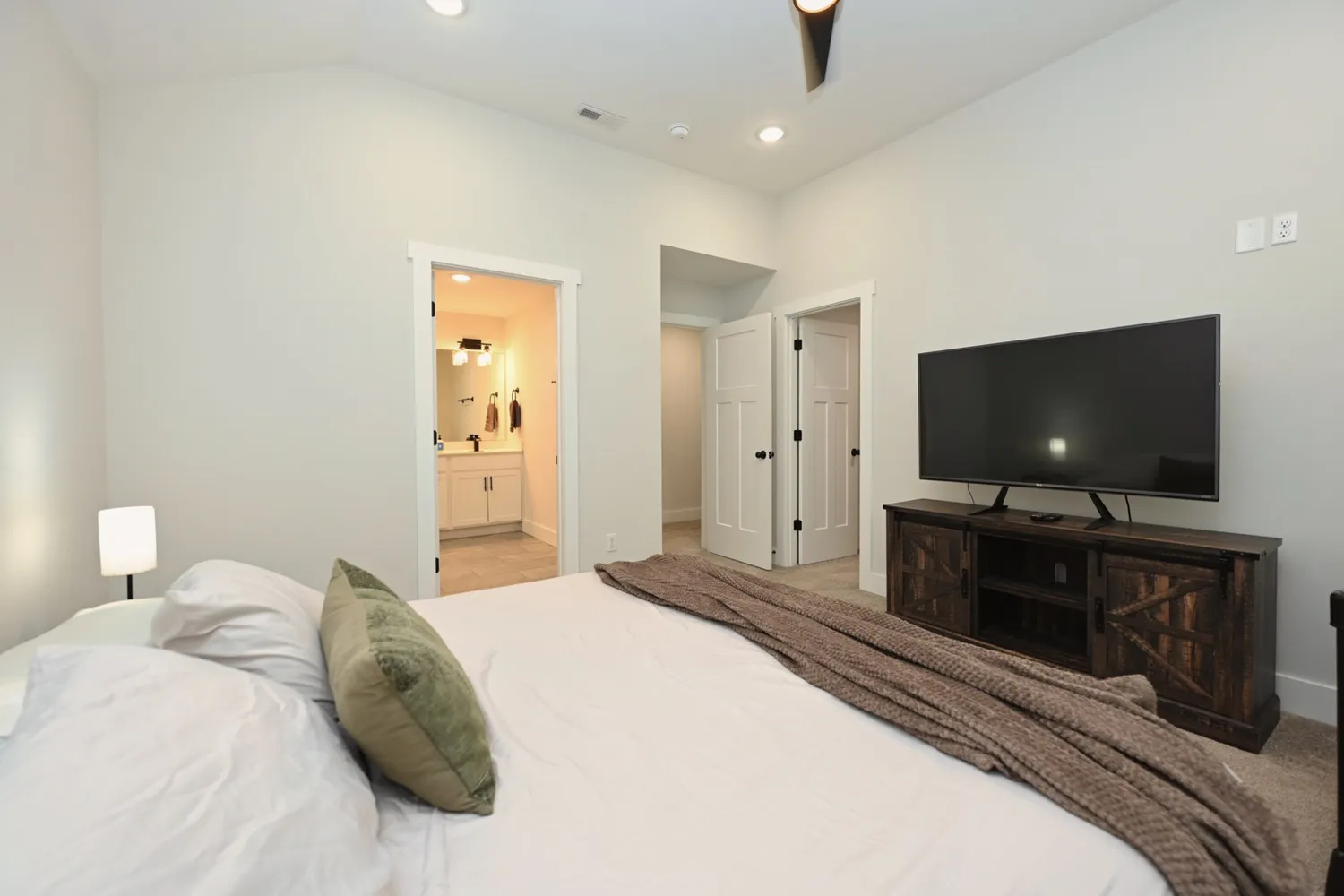 a bedroom with a bed and a flat screen tv