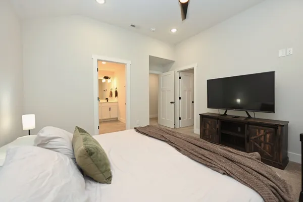 a bedroom with a bed and a flat screen tv