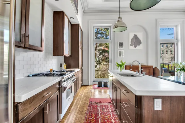 a kitchen with stainless steel appliances granite countertop a stove a sink and a refrigerator